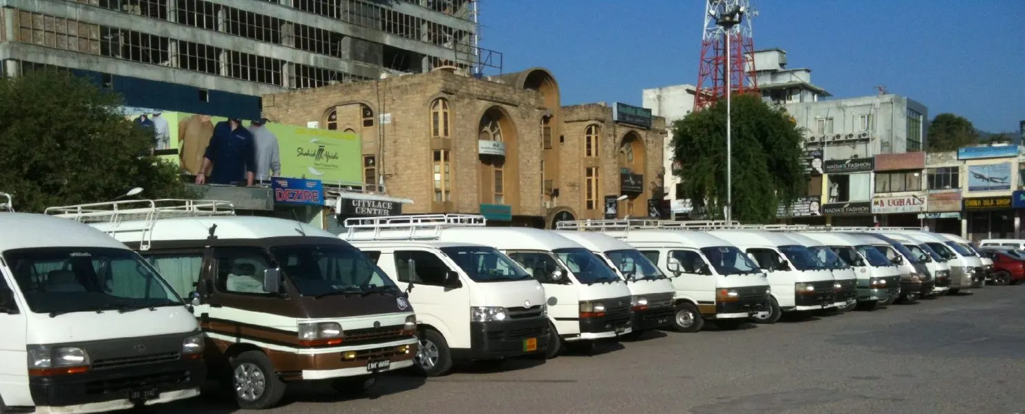 A long line of Amber Tours vans parked in central Islamabad
