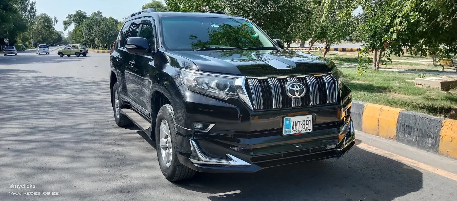 A black Toyota Prado parked on a quiet Islamabad road