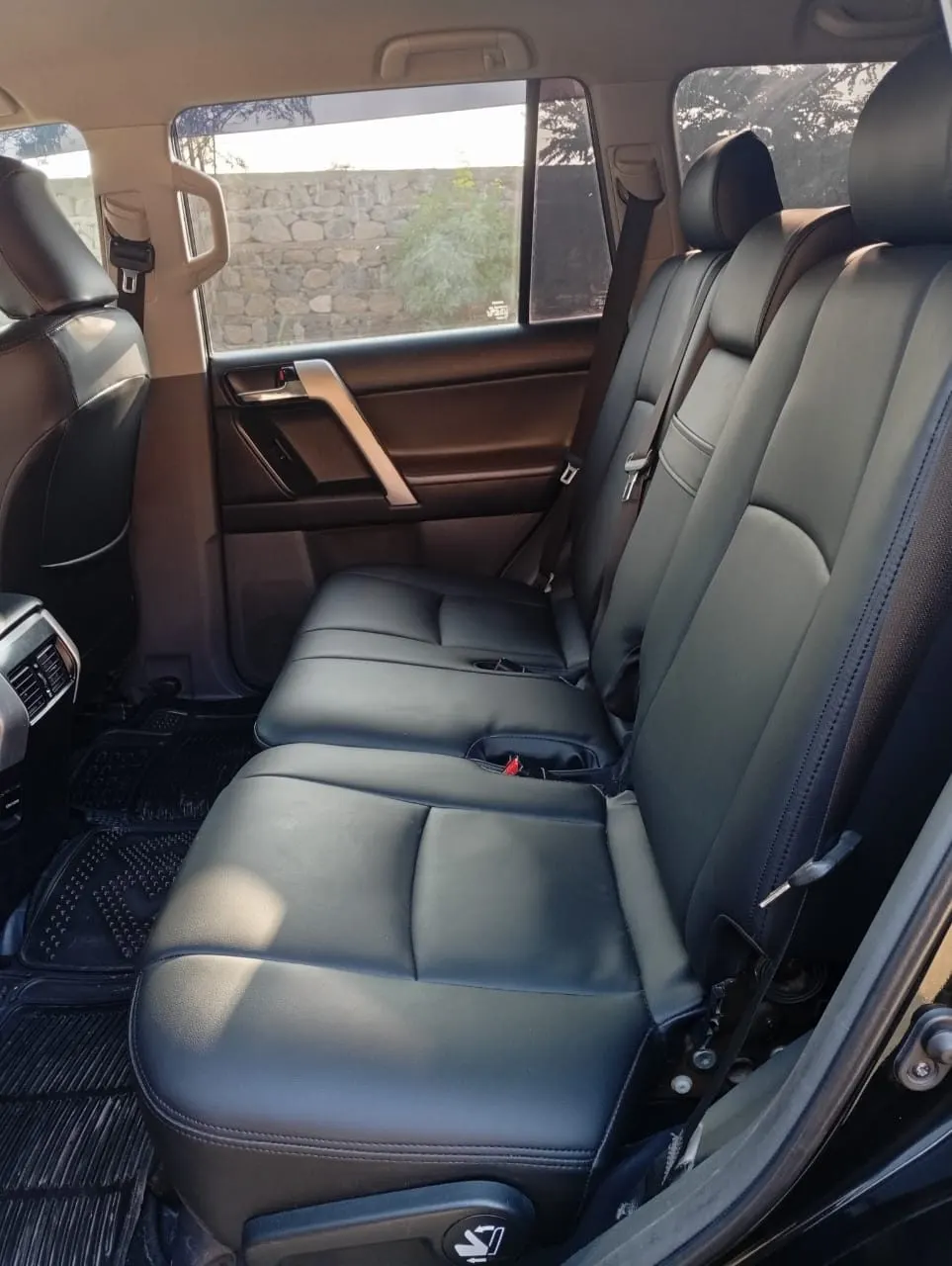 Rear seats of a Toyota Prado in black leather